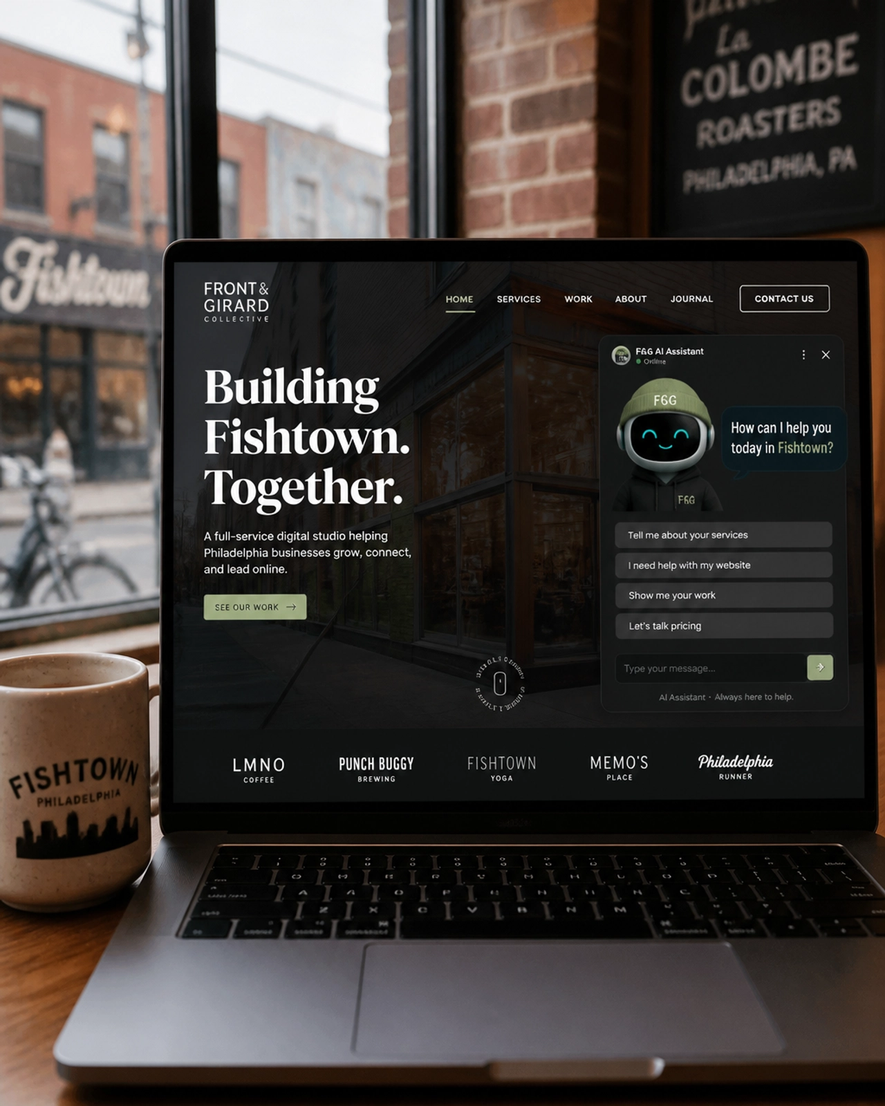 A custom website on a laptop in a Philly coffee shop showing an AI chatbot tailored for Fishtown