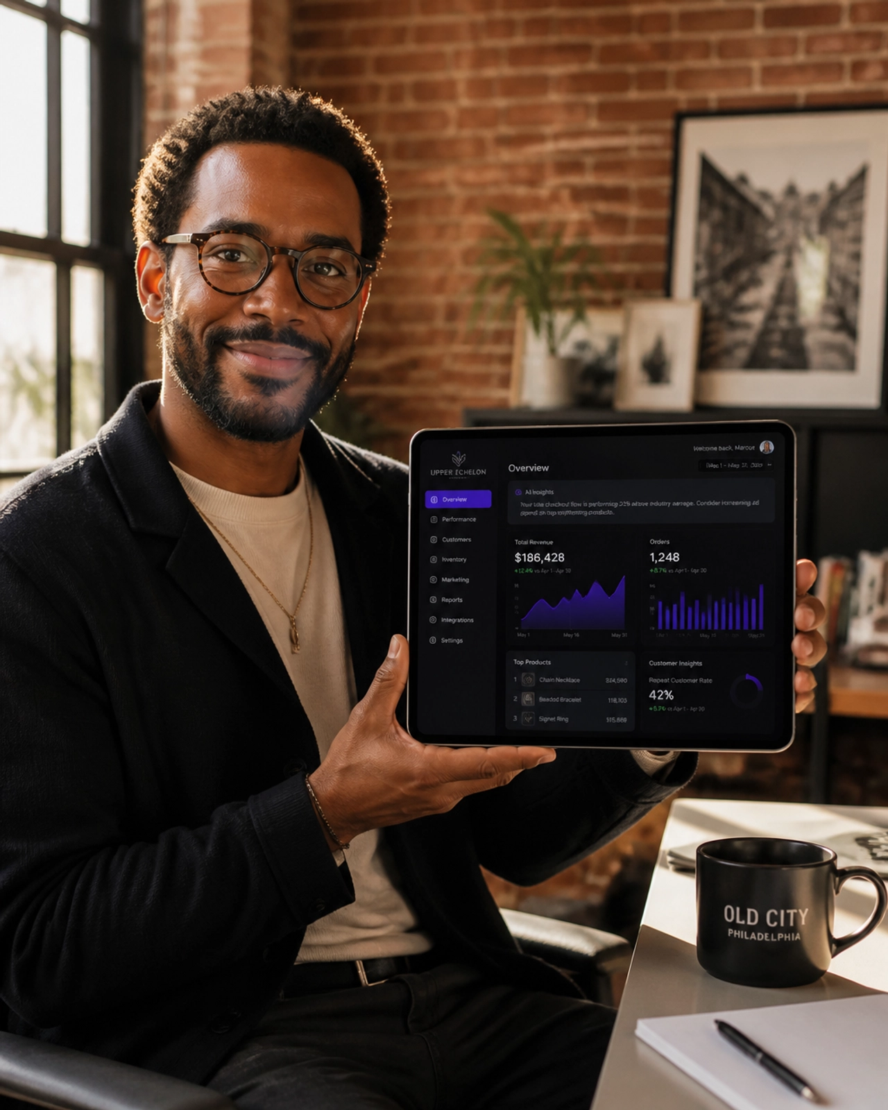 A Philadelphia small business owner in a sunlit Old City office using a custom AI-integrated business dashboard on a tablet